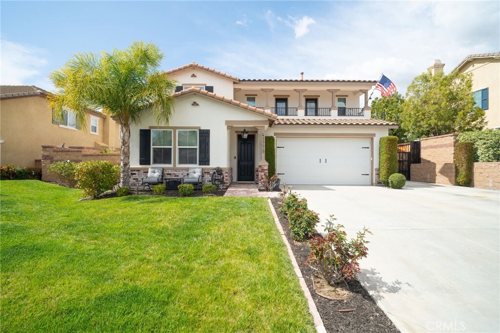 41779 Davidson St, Murrieta, CA 92562 - mediterranean / spanish-style house featuring a balcony, stucco siding, a front yard, a tile roof, and driveway