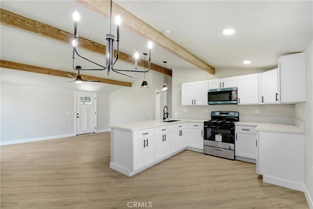 kitchen featuring open floor plan, a peninsula, beam ceiling, stainless steel appliances, and a sink