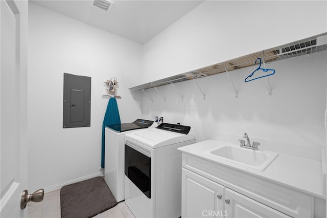 clothes washing area with a sink, visible vents, cabinet space, washing machine and dryer, and electric panel
