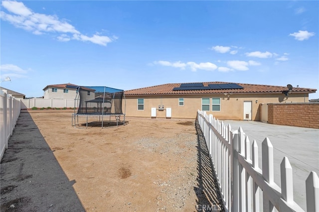 view of yard with a trampoline and a fenced backyard