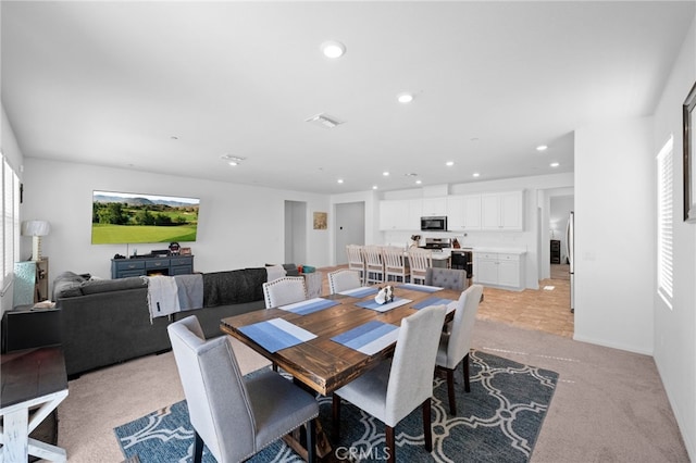 dining area featuring light colored carpet, visible vents, and recessed lighting