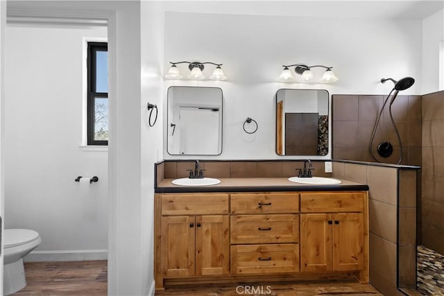 6010 Sunny Ln, Paradise, CA 95969 - full bath with wood finished floors, tiled shower, toilet, double vanity, and baseboards