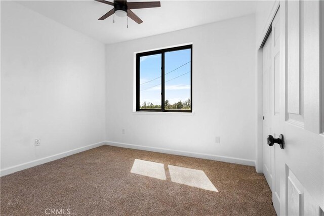 6010 Sunny Ln, Paradise, CA 95969 - unfurnished bedroom with carpet flooring, baseboards, a closet, and a ceiling fan