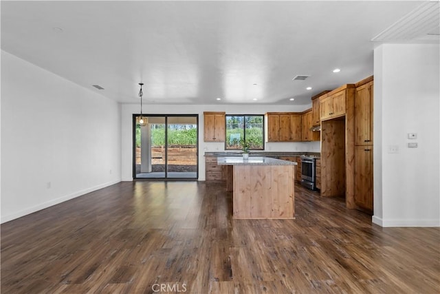 6010 Sunny Ln, Paradise, CA 95969 - kitchen with stainless steel range with electric cooktop, a center island, dark wood-type flooring, brown cabinets, and baseboards