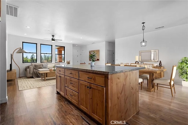 6010 Sunny Ln, Paradise, CA 95969 - kitchen with dark wood-style flooring, a center island, a ceiling fan, pendant lighting, and recessed lighting