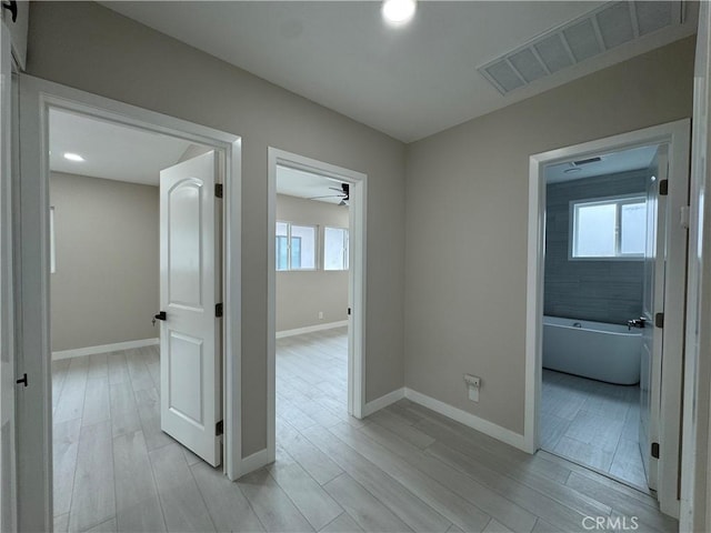4609 Highgrove Ave, Torrance, CA 90505 - hallway featuring healthy amount of natural light, light wood-style flooring, and baseboards
