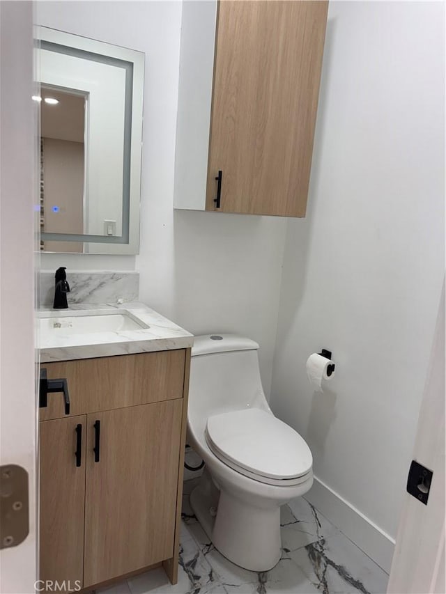 4609 Highgrove Ave, Torrance, CA 90505 - half bathroom featuring marble look tiles, baseboards, toilet, and vanity