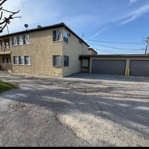 view of side of property featuring stucco siding and a garage