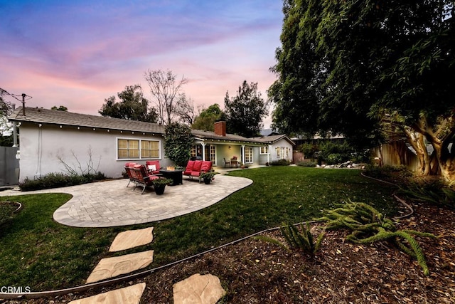 4402 El Camino Corto Ln, Canada Flintridge, CA 91011 - back of house at dusk featuring a patio area, outdoor lounge area, stucco siding, and a chimney