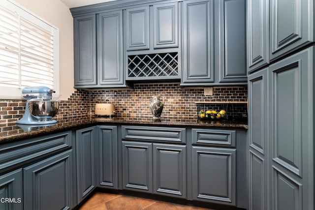 4402 El Camino Corto Ln, Canada Flintridge, CA 91011 - kitchen with backsplash, dark stone counters, and light tile patterned flooring