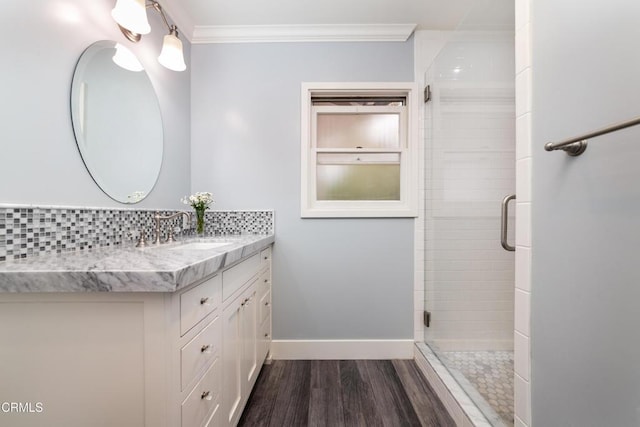 4402 El Camino Corto Ln, Canada Flintridge, CA 91011 - bathroom with ornamental molding, a stall shower, vanity, baseboards, and wood finished floors