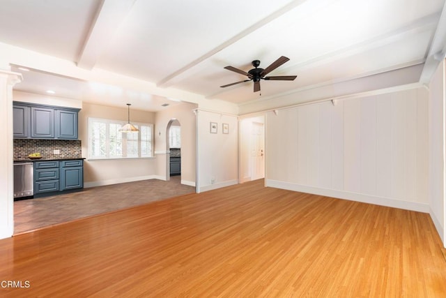 4402 El Camino Corto Ln, Canada Flintridge, CA 91011 - unfurnished living room featuring a ceiling fan, light wood finished floors, arched walkways, baseboards, and beam ceiling