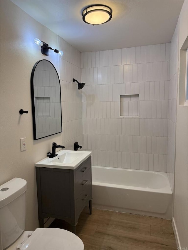 full bathroom featuring shower / tub combination, wood finished floors, toilet, and vanity