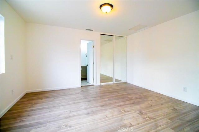 6927 Lindley Ave, Reseda, CA 91335 - unfurnished bedroom featuring wood finished floors, a closet, and baseboards