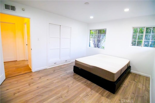 6927 Lindley Ave, Reseda, CA 91335 - bedroom with light wood-style floors, multiple windows, recessed lighting, and baseboards
