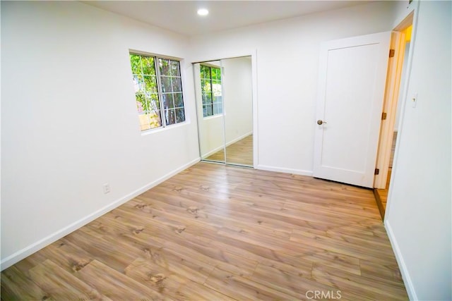 6927 Lindley Ave, Reseda, CA 91335 - unfurnished bedroom featuring baseboards, light wood-style flooring, recessed lighting, and a closet