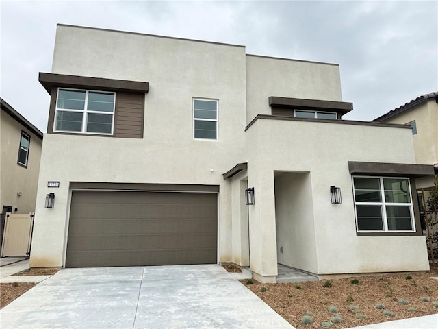 15746 Catrepillar, Fontana, CA 92336 - view of front of property with driveway, stucco siding, and a garage