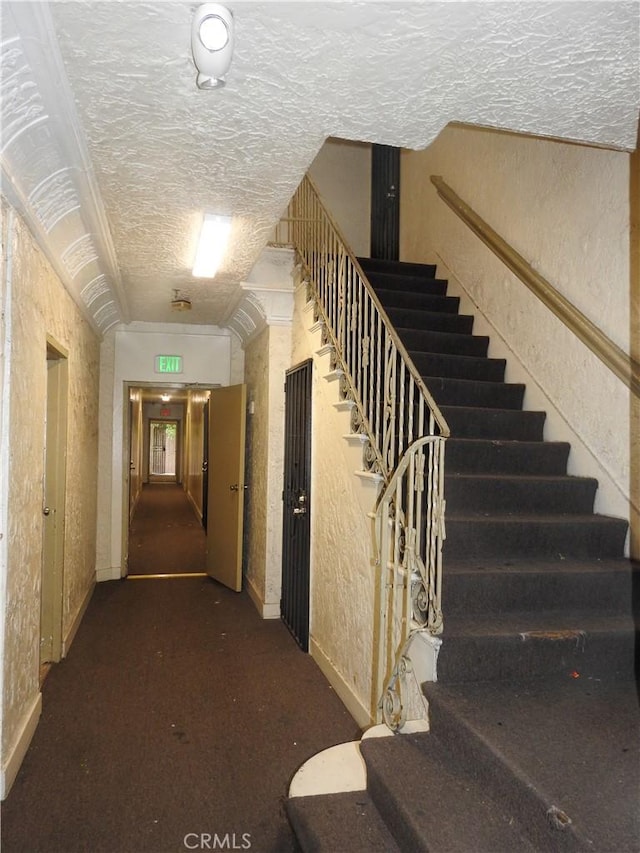 5617 La Mirada Ave, Los Angeles, CA 90038 - corridor with stairs, a textured ceiling, and a textured wall