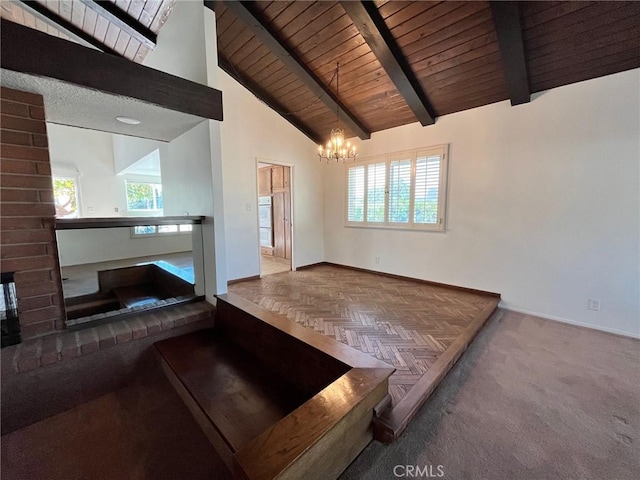 unfurnished living room featuring high vaulted ceiling, wood ceiling, a brick fireplace, a notable chandelier, and beam ceiling