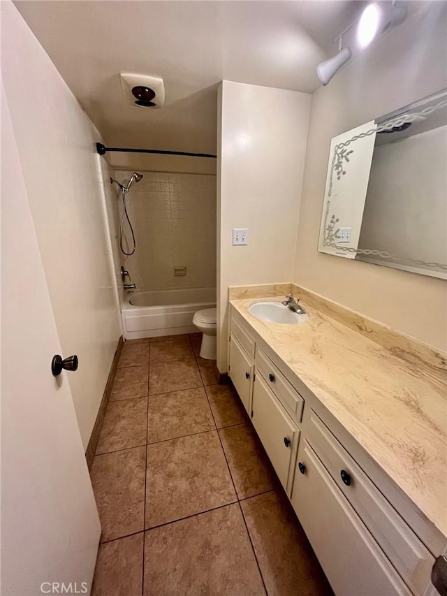 bathroom featuring vanity, baseboards, tile patterned floors, shower / bath combination, and toilet