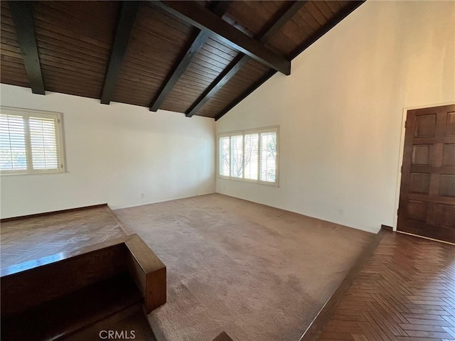 unfurnished living room with high vaulted ceiling, wood ceiling, and beam ceiling