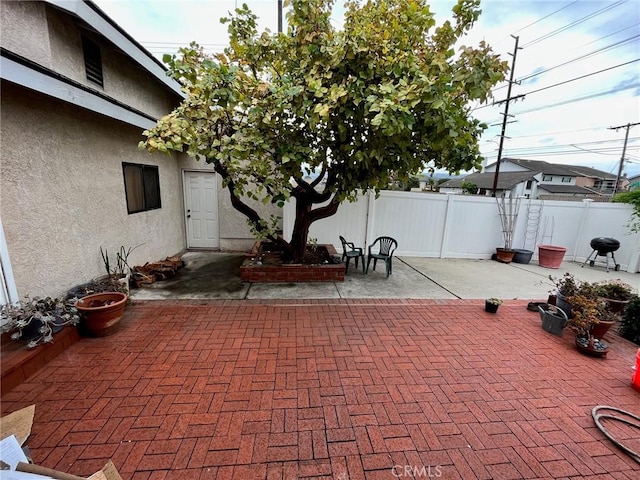view of patio / terrace featuring fence