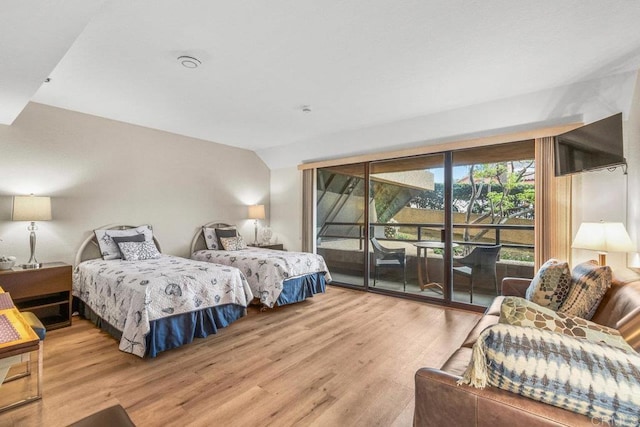 230 W Laurel St Unit 506, San Diego, CA 92101 - bedroom featuring access to outside, wood finished floors, and vaulted ceiling