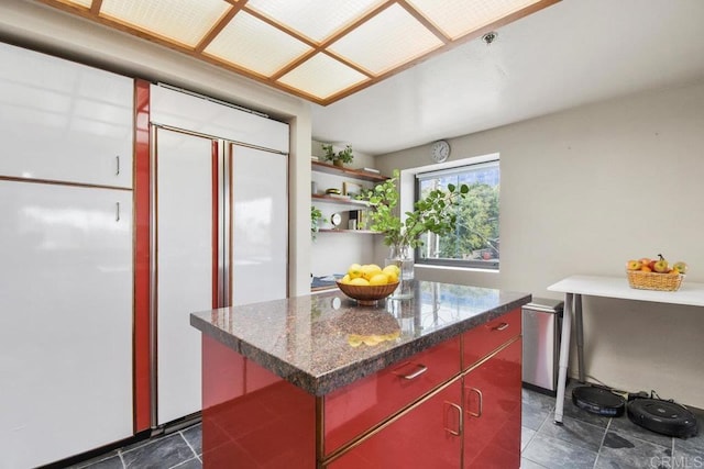 230 W Laurel St Unit 506, San Diego, CA 92101 - kitchen with paneled built in fridge, dark countertops, a kitchen island, and open shelves
