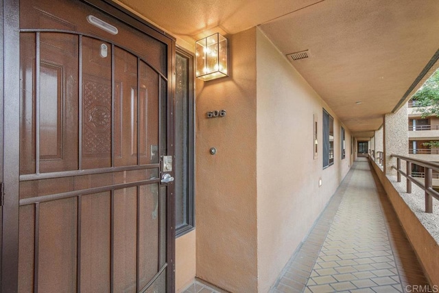 230 W Laurel St Unit 506, San Diego, CA 92101 - view of exterior entry with stucco siding and a balcony