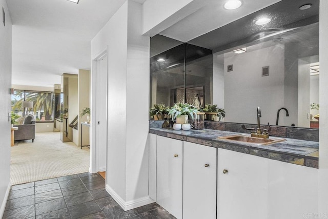 230 W Laurel St Unit 506, San Diego, CA 92101 - bar with a sink, baseboards, and dark stone finish floors