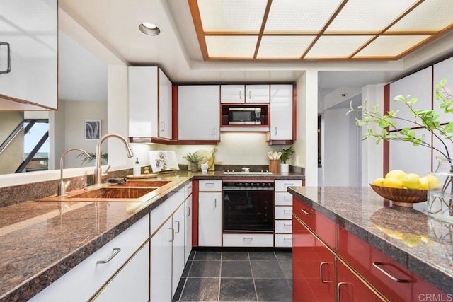 230 W Laurel St Unit 506, San Diego, CA 92101 - kitchen featuring wall oven, stainless steel microwave, a sink, white cabinetry, and stovetop