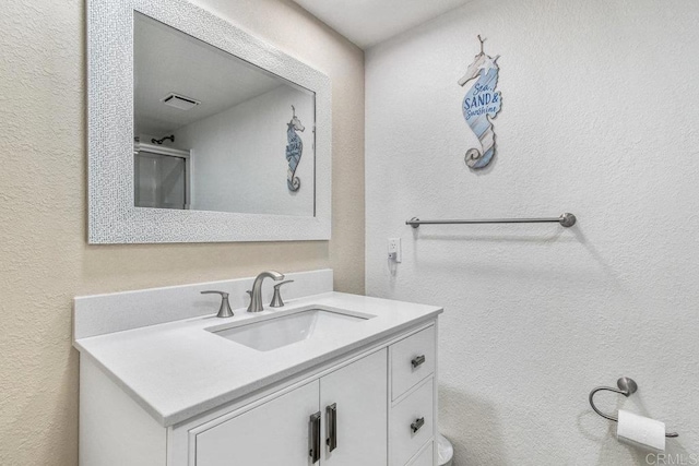 230 W Laurel St Unit 506, San Diego, CA 92101 - bathroom with vanity and a textured wall