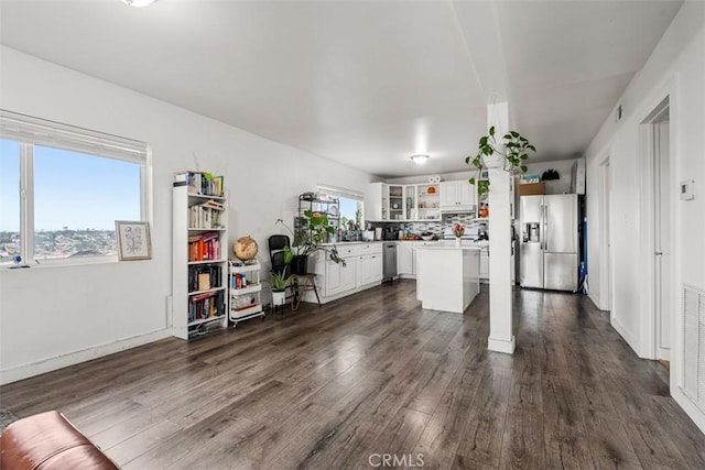 kitchen with white cabinetry, light countertops, appliances with stainless steel finishes, and dark wood finished floors