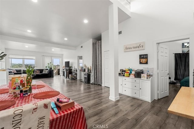 living area featuring recessed lighting, dark wood-type flooring, and visible vents