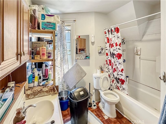 full bath with a sink, shower / bathtub combination with curtain, and toilet