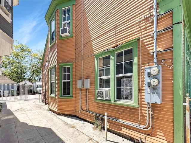 view of property exterior featuring fence and cooling unit