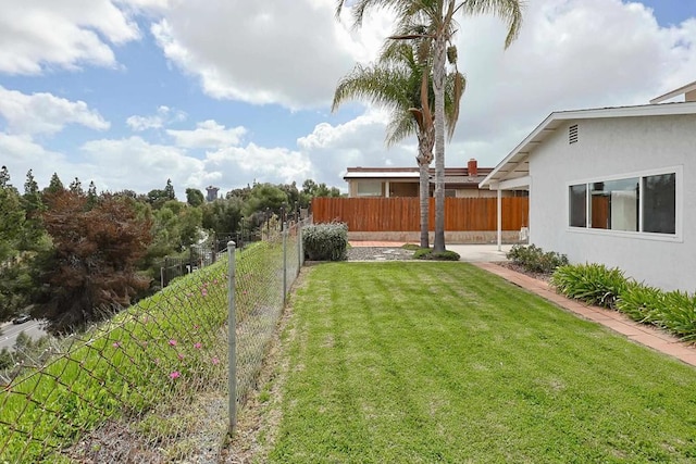 view of yard with a patio area and a fenced backyard