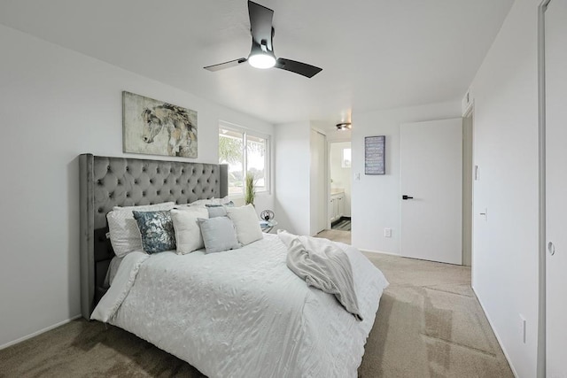bedroom featuring carpet, ensuite bath, and ceiling fan