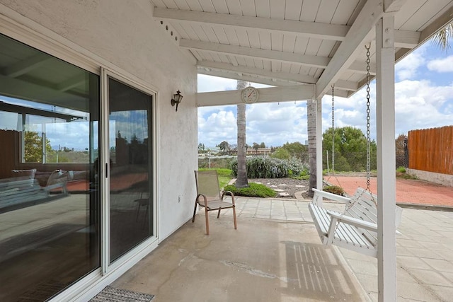 view of patio featuring fence