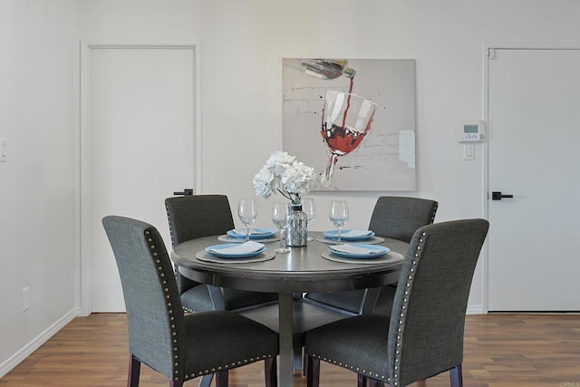 dining room featuring baseboards and wood finished floors