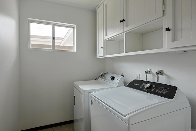 laundry area with cabinet space, washing machine and clothes dryer, and baseboards