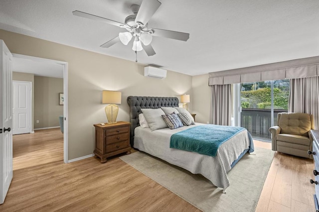 1562 Camino Del Mar Unit 643, Del Mar, CA 92014 - bedroom featuring access to outside, light wood-style floors, a wall mounted air conditioner, baseboards, and ceiling fan