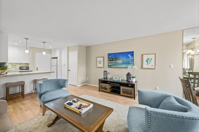 1562 Camino Del Mar Unit 643, Del Mar, CA 92014 - living room with light wood finished floors and recessed lighting