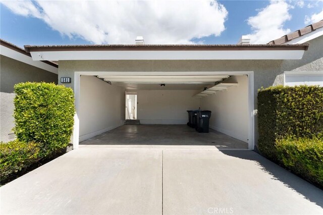 581 Springbrook N, Irvine, CA 92614 - view of parking featuring driveway and an attached garage