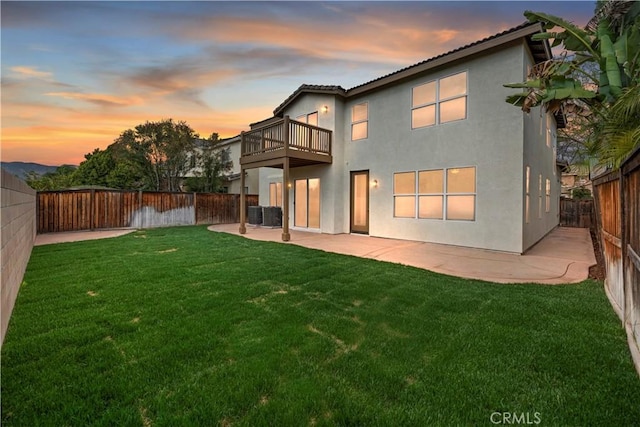 1984 Bronte Rd, San Jacinto, CA 92583 - back of house featuring a balcony, a patio, a fenced backyard, a lawn, and stucco siding