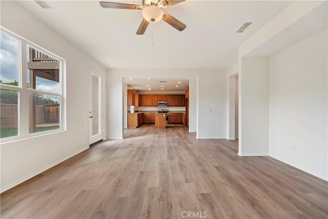 1984 Bronte Rd, San Jacinto, CA 92583 - unfurnished living room with light wood-style flooring, baseboards, ceiling fan, and visible vents