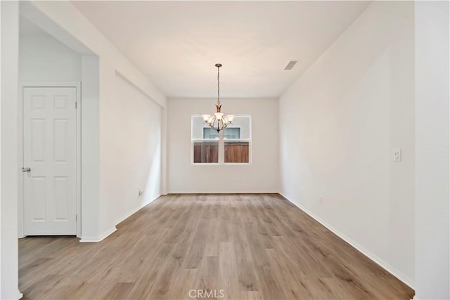 1984 Bronte Rd, San Jacinto, CA 92583 - empty room with a notable chandelier, baseboards, light wood finished floors, and visible vents