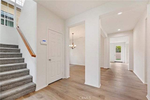 1984 Bronte Rd, San Jacinto, CA 92583 - interior space with stairs, light wood-type flooring, baseboards, and an inviting chandelier