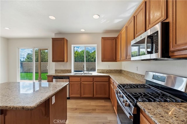 1984 Bronte Rd, San Jacinto, CA 92583 - kitchen featuring brown cabinets, light stone counters, a sink, and stainless steel appliances