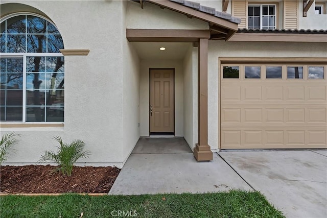 1984 Bronte Rd, San Jacinto, CA 92583 - doorway to property featuring stucco siding and an attached garage